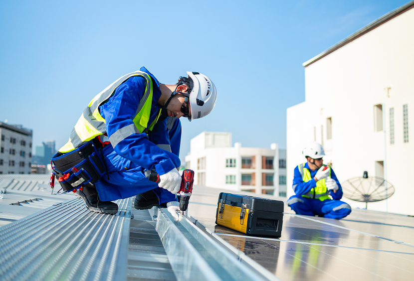 Construction team working on rooftop solar installation