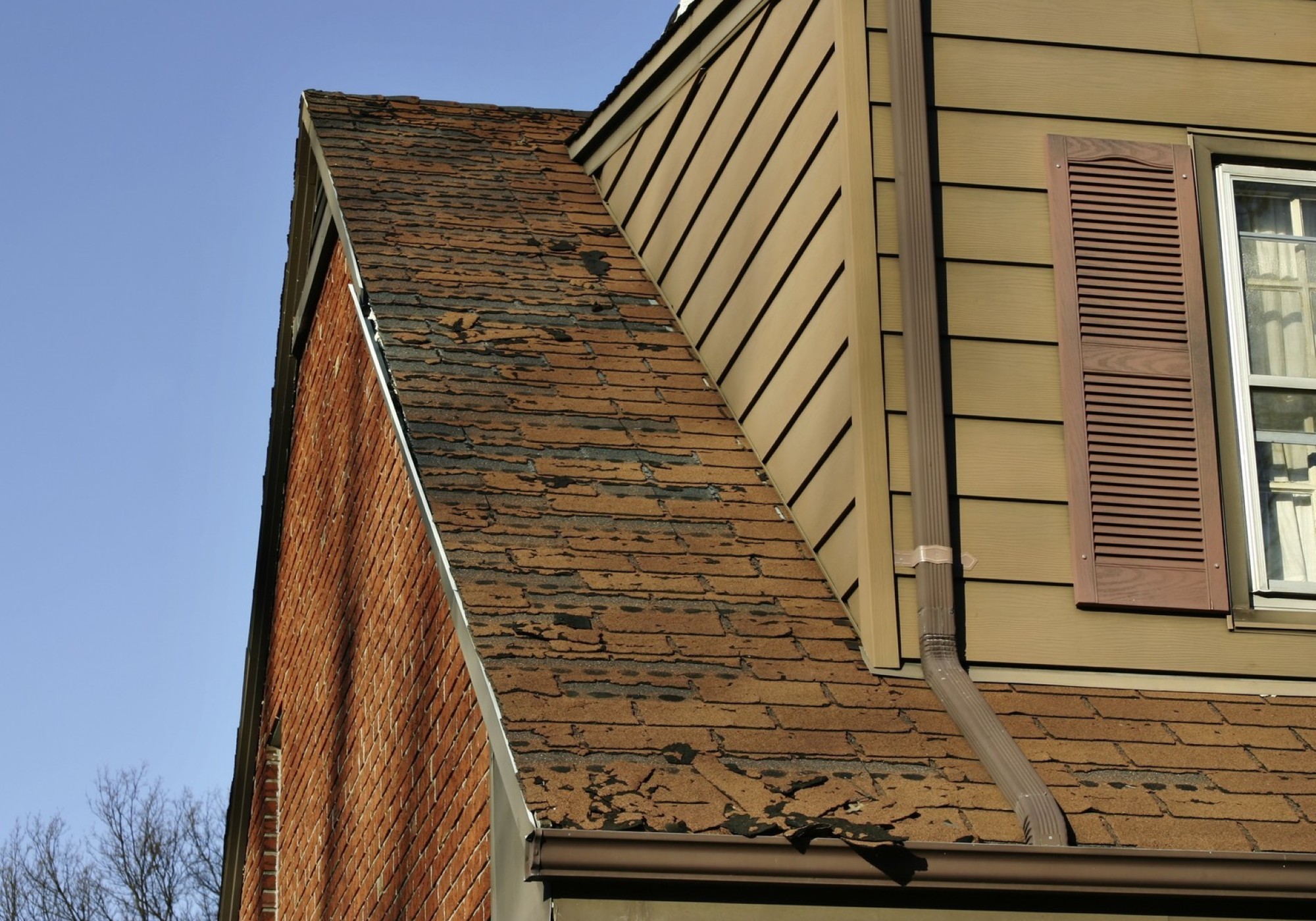 Old roof with damaged shingles