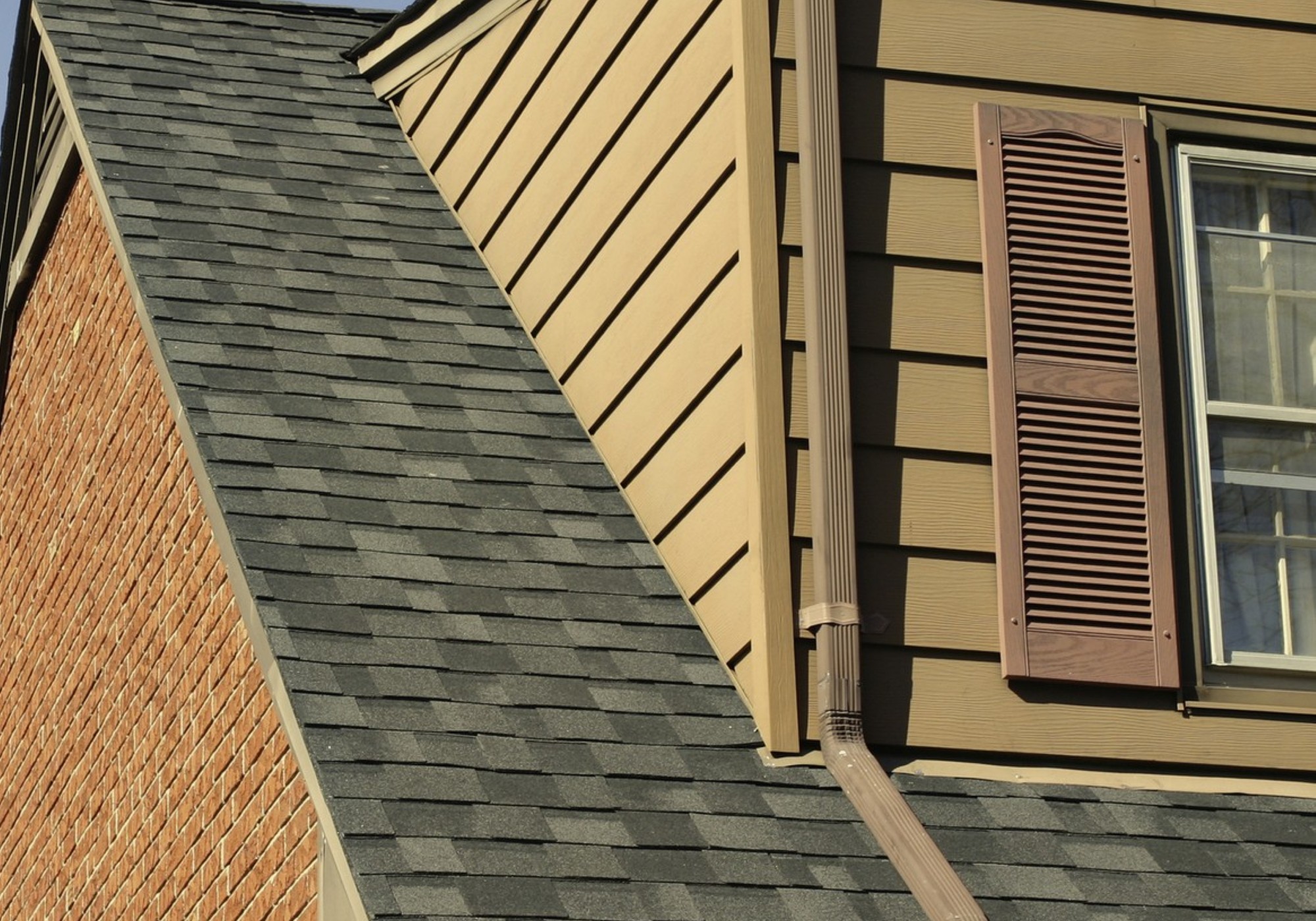 Window with brown shutters on house