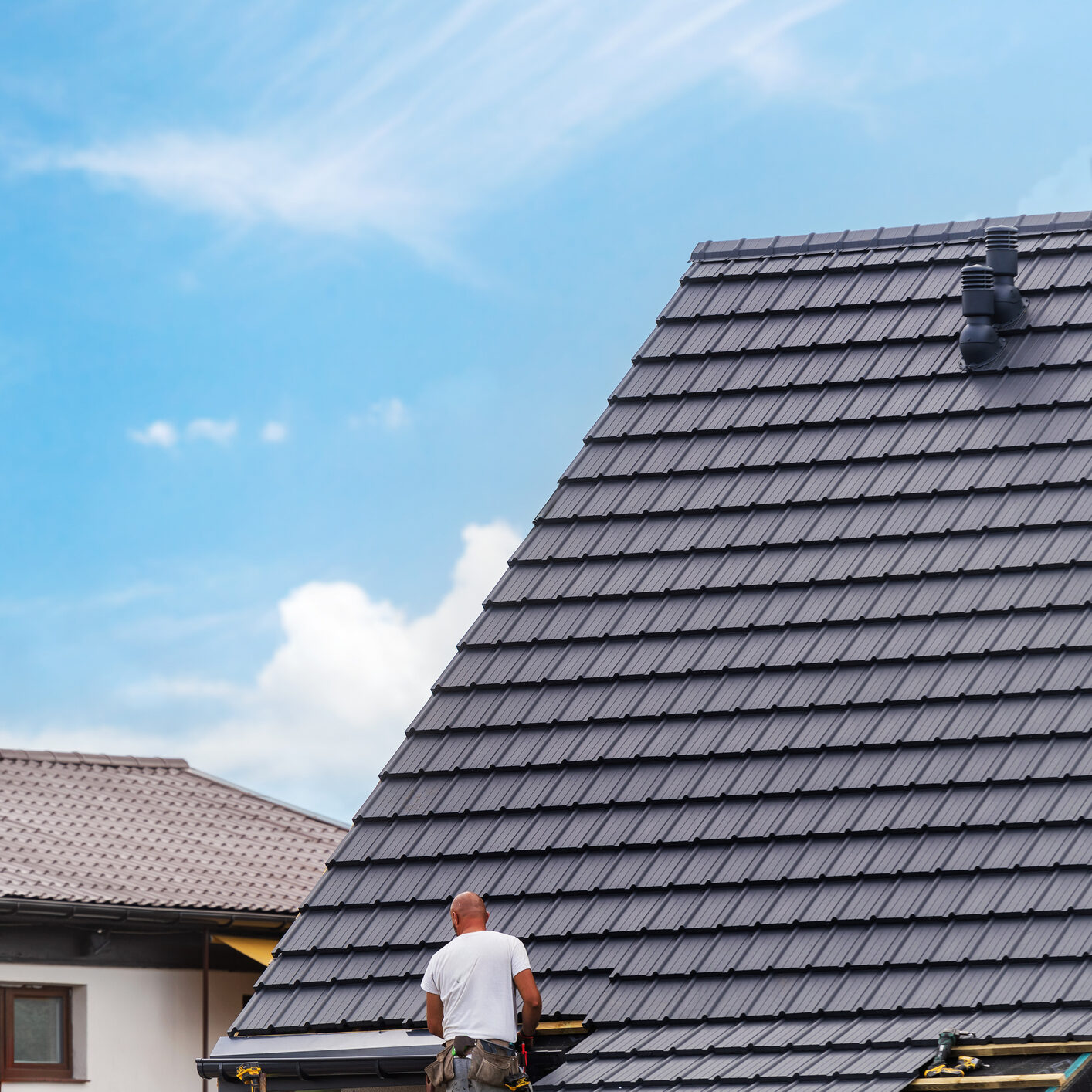 Construction worker on partially built roof.