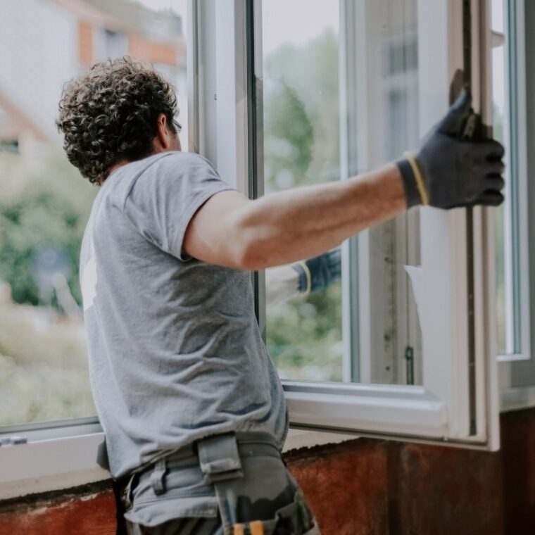 Man installing a window frame